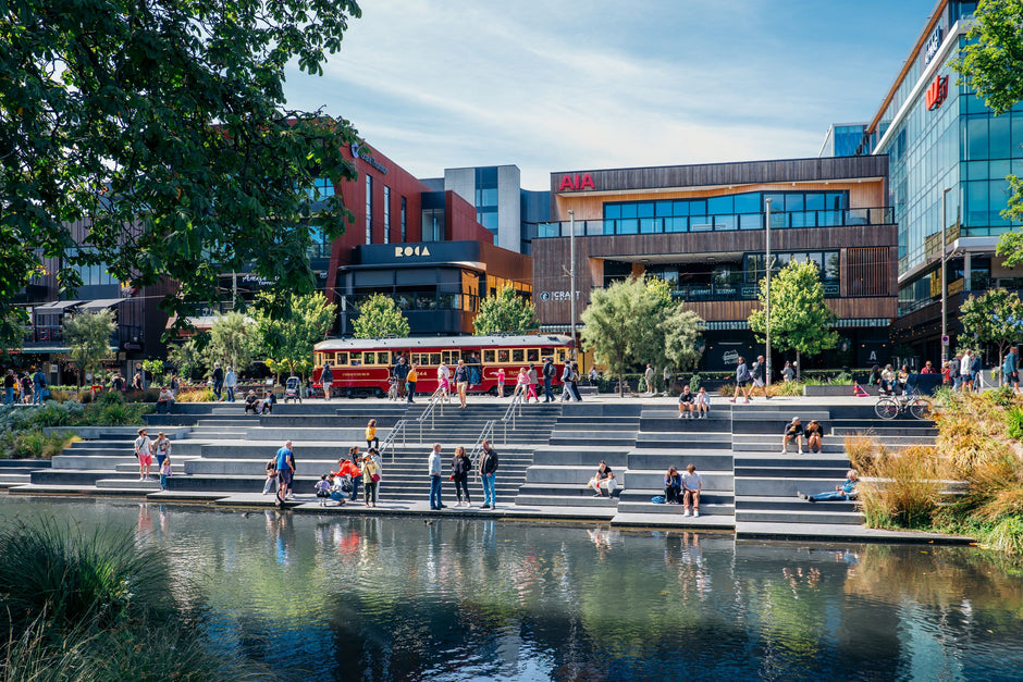 People sitting near Avon in downtown Christchurch