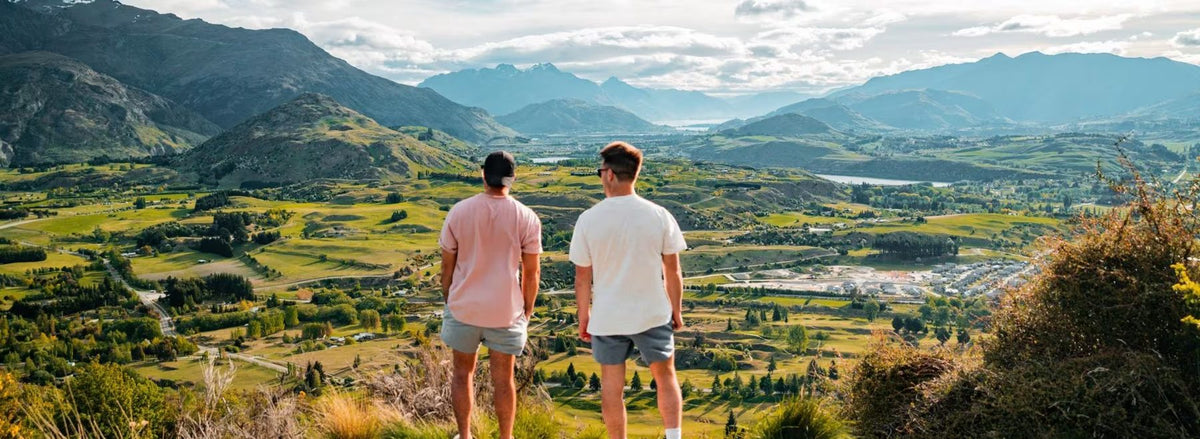 Two walkers looking out over the Wakatipu Basin from Tobins Track above Arrowtown