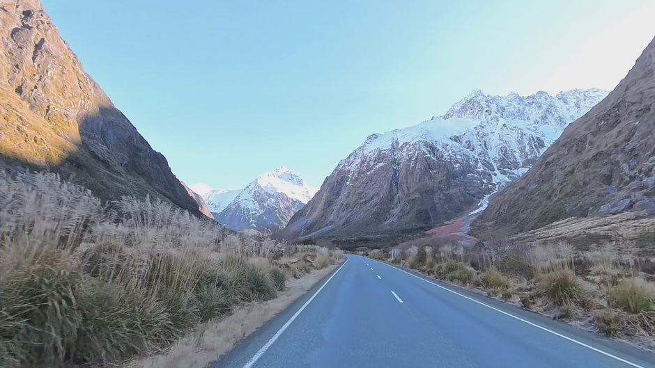 Driving the Milford Road towards snow-covered peaks